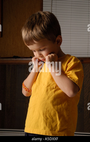 4 year old boy lowers head in shame 2 Stock Photo