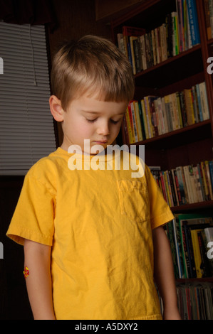 4 year old boy lowers head in shame 3 Stock Photo