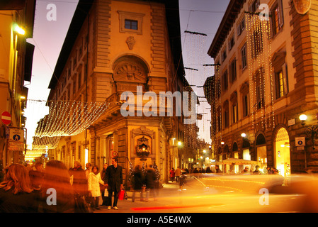 Florence Christmas shoppers hurried night-time Christmas lights and decorations, Florence Italy Stock Photo