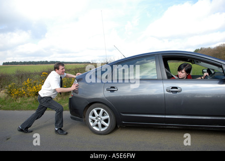 Male pushing broken down car. Stock Photo