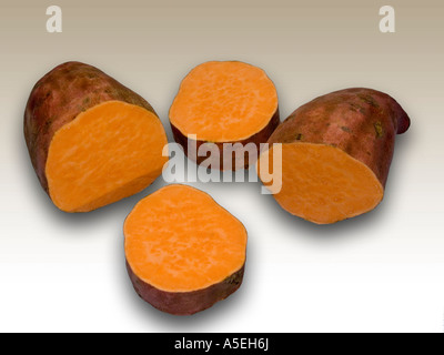 Vegetable - orange sweet potato Beauregard and cut slices on a light coloured background Stock Photo
