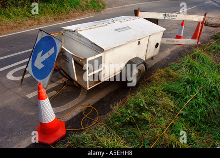 A MOBILE GENERATOR BEING USED TO POWER TEMPORARY TRAFFIC LIGHTS AT A ROAD WORKS UK Stock Photo