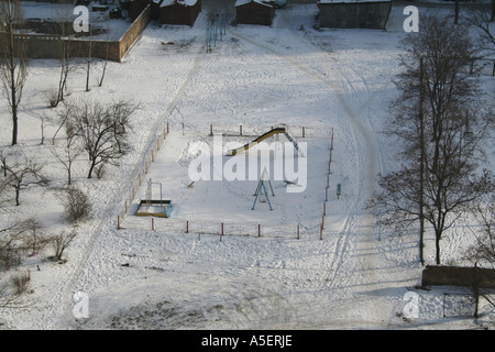 Snowy playground in Kyiv, deserted under winter's chill. Stock Photo