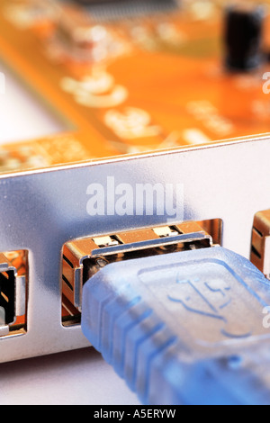 Computer USB cable connecting to port Stock Photo