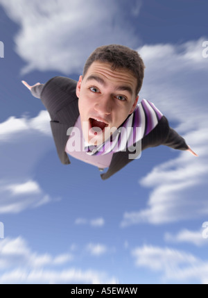 Man s body moving toward on the blue cloudy sky Focus on the eyes the rest blured Stock Photo