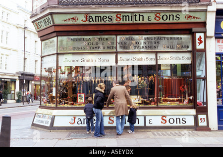 A family looking at the window display of a shop in High Holborn London Stock Photo