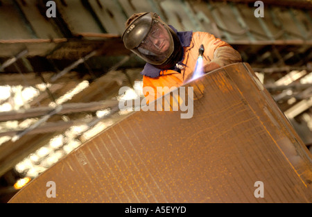 Engineers fabricate part of a steel foot and cycle bridge to cross the River Usk at Newport Gwent South Wales UK Stock Photo