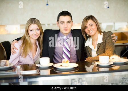 Man and Women at the Bar Looking at the Camera and Smiling Short Depth of Focus On Their Faces Stock Photo