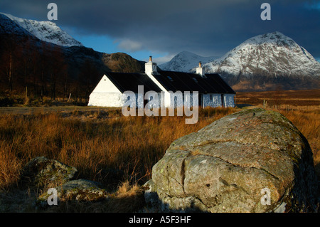 Black Rock Cottage, with with snow capped  Buachaille Etive Mor background, Lochaber, Scotland Stock Photo