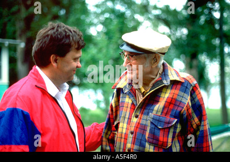 Man age 41 speaking with father in law age 87 at lake cabin. Clitherall Minnesota USA Stock Photo