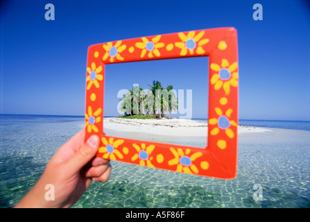 Hand holding frame showing small tropical island in Belize Central America Caribbean Stock Photo