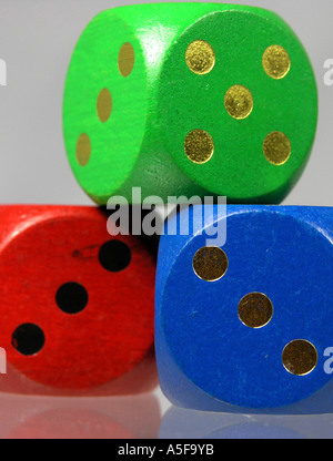 Three wooden coloured dice in a stack Stock Photo