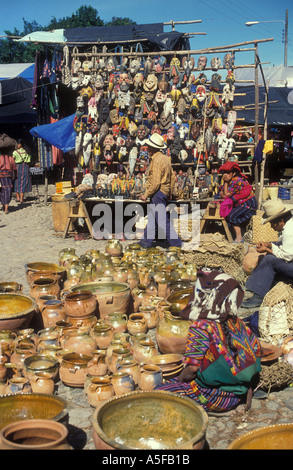 Pottery and wooden masks on sale Chichicastenango market Guatemala Stock Photo