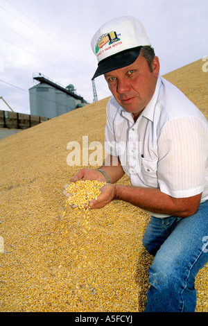 Farmer showing his harvested crop in a field Stock Photo - Alamy