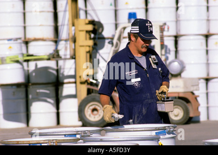 Technician using a Geiger Counter to sample radioactive waste at a storage facility in Idaho Stock Photo