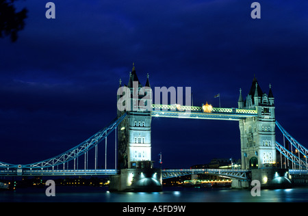 The Tower Bridge across the River Thames at night in London England Stock Photo