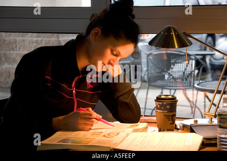 Female college student studying at a coffee shop in Boise Idaho Stock Photo