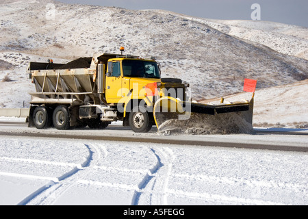 A snow plow removing snow from the road near Boise Idaho Stock Photo