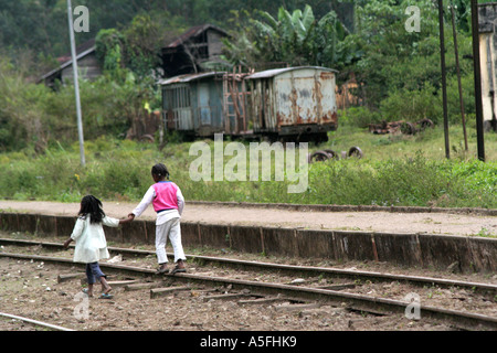 girls walk on the railroad track in rural Andasibe, Madagascar Stock Photo