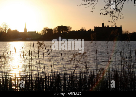 Sunset over the Park Lake, Lurgan with Brownlow House and the town in silhouette, County Armagh, Northern Ireland Stock Photo