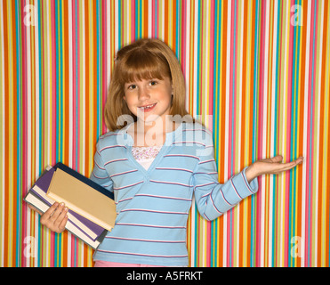 Caucasian female child holding books Stock Photo