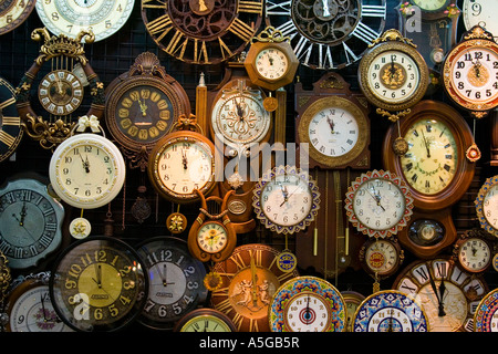 Wall of Clocks in a Store Stock Photo