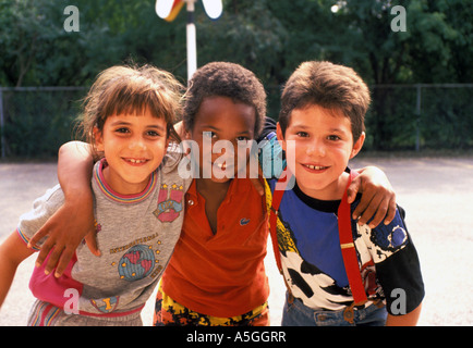 portrait of three children of different nationalities embracing each other, USA Stock Photo