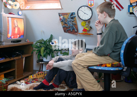 portrait of two young boys glued to the television Stock Photo