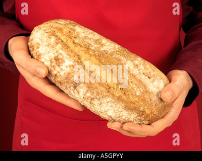 MAN HOLDING CRUSTY WHITE BREAD Stock Photo