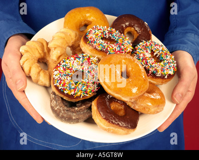 MAN HOLDING PLATE OF DOUGHNUTS Stock Photo