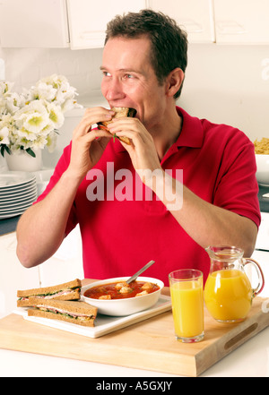 MAN EATING SANDWICH LUNCH Stock Photo