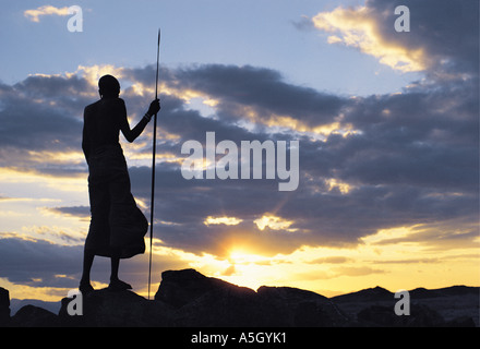 Rendille elder with spear silhouetted against the sunset sky Korr northern Kenya East Africa Stock Photo