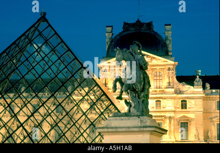 Paris France, 'I.M Pei' Pyramid at the 'Louvre Museum' with Statue of 'King Louis XIV' Artist Bernin 'Lit up' at Night View Stock Photo