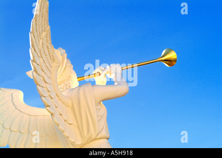 female angel statue blowing trumpet Stock Photo