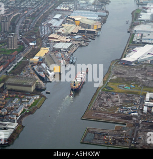 Container ship being escorted up the river clyde, past Clydeside Shipbuilders, Scotland, February 2007 Stock Photo