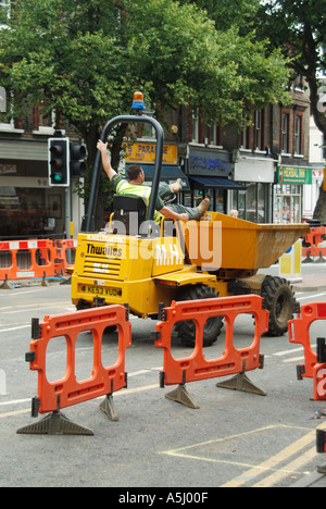 Brentwood High street closed to traffic for road works involving repairs to old water mains dumper truck driver awaiting next lo Stock Photo