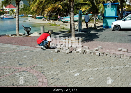 Paviour laying paving blocks, St Maarten Stock Photo