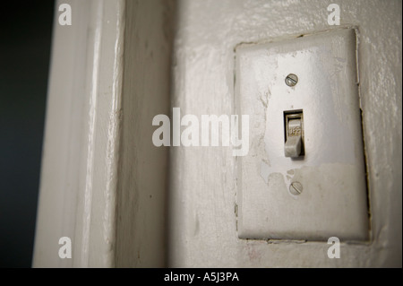 View of a white electric American power switch in the OFF position on a wall February 2006 Stock Photo