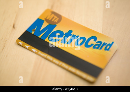 An MTA Metrocard lies on a wooden table surface February 2006 Stock Photo