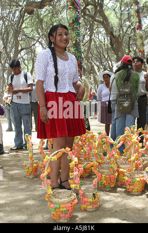 Young traditional woman with colourful decorated baskets for the Wallunk'a ( Swing) in Tiataco, Cochabamba, Bolivia Stock Photo