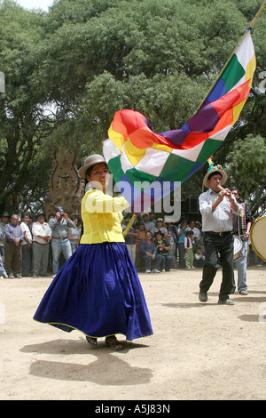 Young Traditional Woman dancing with a wiphala  (flag) in Tiataco, Cochabamba, Bolivia Stock Photo