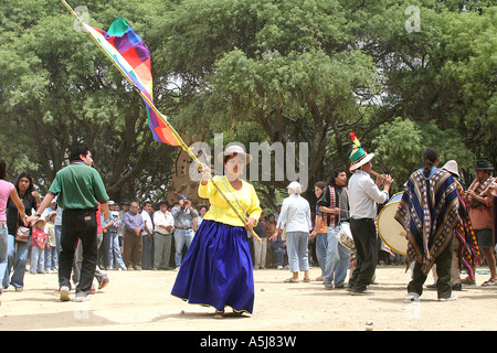 Young Traditional Woman dancing with a wiphala  (flag) in Tiataco, Cochabamba, Bolivia Stock Photo