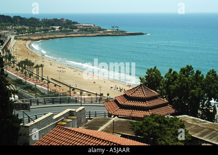 Looking down from above at people on sandy holiday beach on Spanish Mediterranean Sea coastline landscape at Tarragona Costa Daurada Catalonia Spain Stock Photo