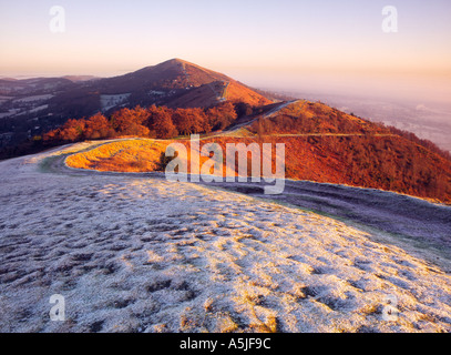 Shire ditch and Worcestershire Beacon on a frosty morning at dawn in the Malvern Hills Worcestershire England Stock Photo
