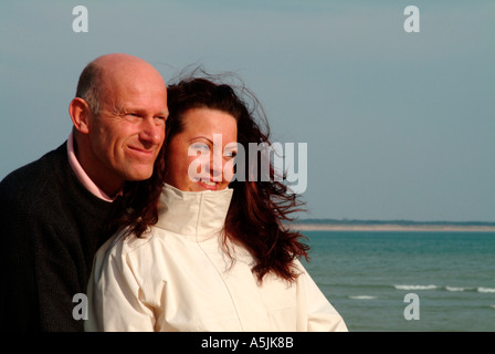 MR lovers walking at seacoast looking together ahead Stock Photo