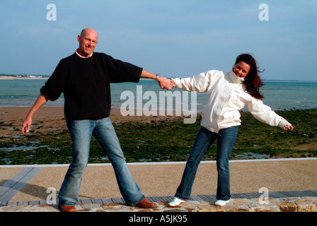 MR lovers at seacoast hand in hand Stock Photo