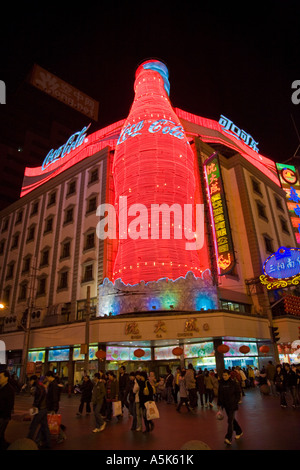 Neon lights make huge Coca Cola bottle at night Nanjing Road Dong Lu shopping street Shanghai China JMH2337 Stock Photo