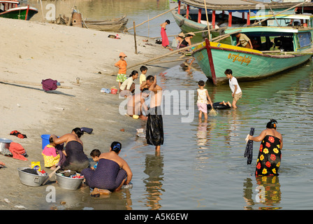 Woman washing clothes in the Irrawaddy, Myanmar Stock Photo