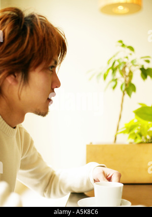 Young man with coffee cup Stock Photo
