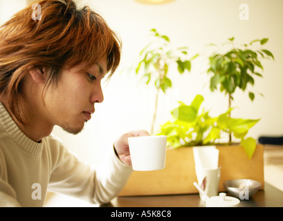 Young man drinking coffee Stock Photo